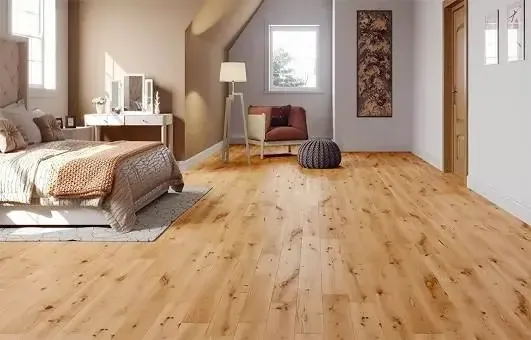 Bright and cozy bedroom featuring wooden floors, a bed with textured linens