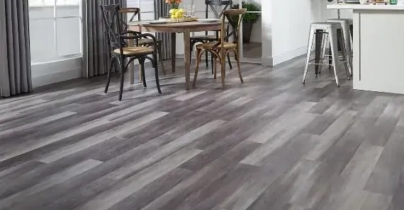 Modern dining area featuring dark gray wood-like flooring