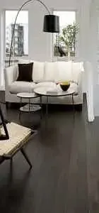 Modern living room featuring a white sofa with dark cushions