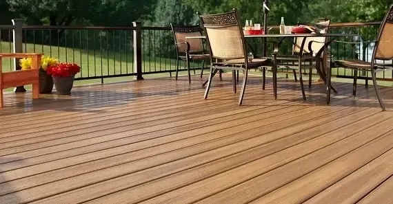 wooden deck features a dining table with chairs